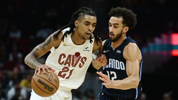 Oct 12, 2023; Cleveland, Ohio, USA; Cleveland Cavaliers forward Emoni Bates (21) drives to the basket against Orlando Magic guard Trevelin Queen (12) during the second half at Rocket Mortgage FieldHouse. 